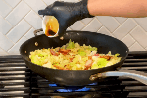 Add soy sauce for Crispy Bacon and Savory Cabbage Stir-Fry
