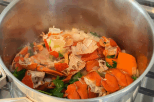 Cook lobster soup for Lobster Fettuccini with Shell Broth