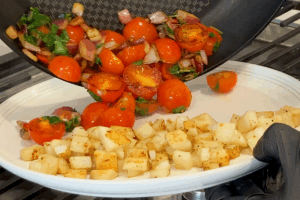 Cook the tomatoes for Steak and Eggs Breakfast