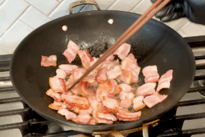 Cook bacon for Crispy Bacon and Savory Cabbage Stir-Fry