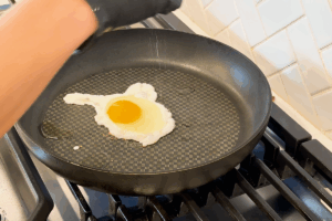 Fry the eggs for Steak and Eggs Breakfast