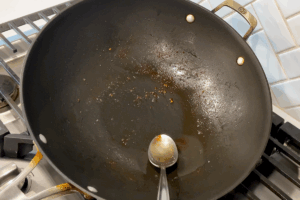 Remove excess fat for Crispy Bacon and Savory Cabbage Stir-Fry