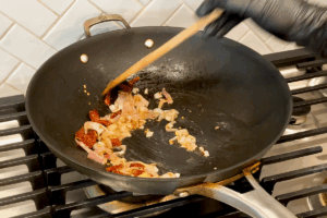 Sauté aromatics for Crispy Bacon and Savory Cabbage Stir-Fry