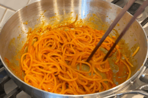 Toss the pasta for Spicy Gochujang Buttered Noodles