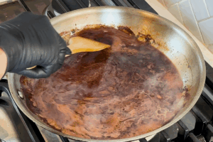 Deglaze with red wine for Authentic Beef Bourguignon