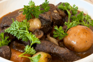 Garnish with Italian parsley for Authentic Beef Bourguignon
