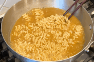 Cook the noodles for Instant Noodle Upgrade with thin beef