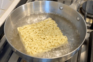 Cook the noodles for Creamy Instant Noodle Carbonara Hack