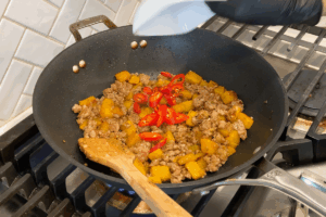Add Fresno chili for gentle heat and color for Golden Pumpkin Pork Stir-Fry
