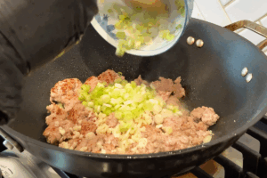 Build the sauce with garlic and green onions for Golden Pumpkin Pork Stir-Fry