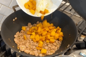 Return pumpkin to the wok for Golden Pumpkin Pork Stir-Fry