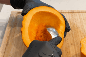 Scoop out the seeds with a spoon for Golden Pumpkin Pork Stir-Fry