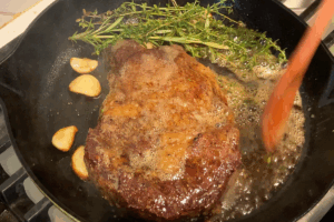 Add Aromatics and Baste for Reverse-Seared Ribeye