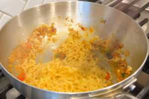 Add the noodles for Creamy Carbonara Instant Noodles